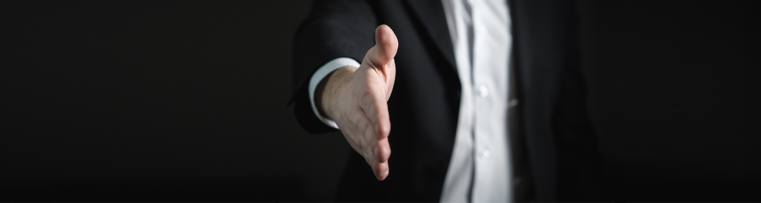 Image of interviewer extending their hand to shake